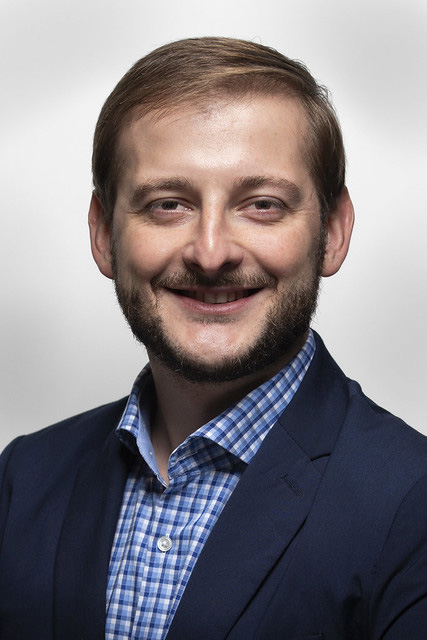 Man with blonde hair, navy jacket