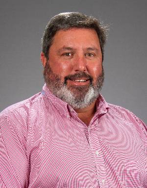 Man with black and gray beard and checked shirt