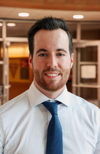 Man with white shirt, tie, dark hair