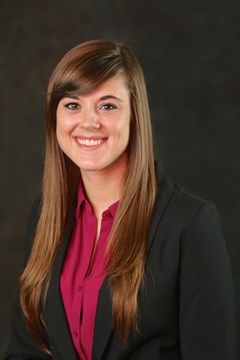 Long-haired woman with red shirt and black suit