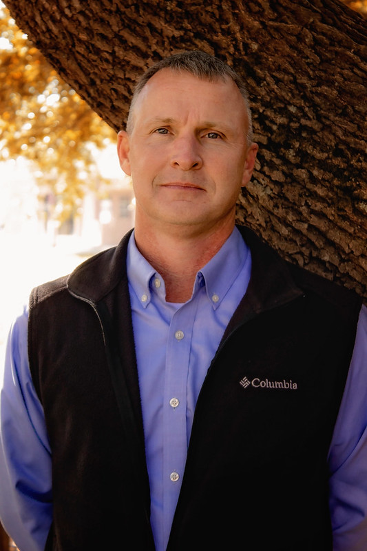 Les Walz in front of a tree